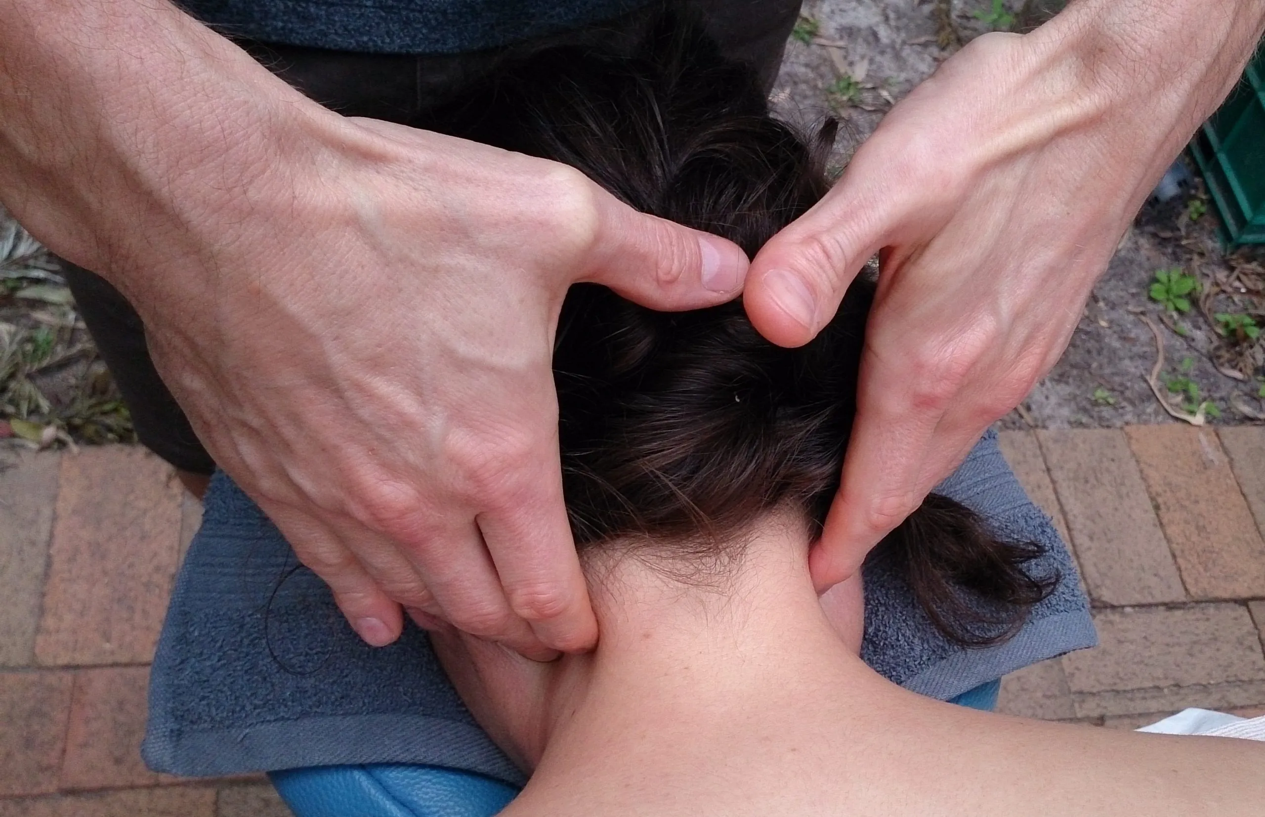 A massage therapist working on a client’s neck and shoulders